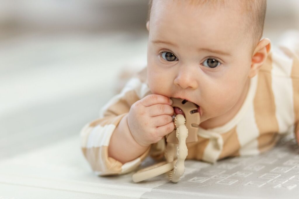 baby playing with teething toy