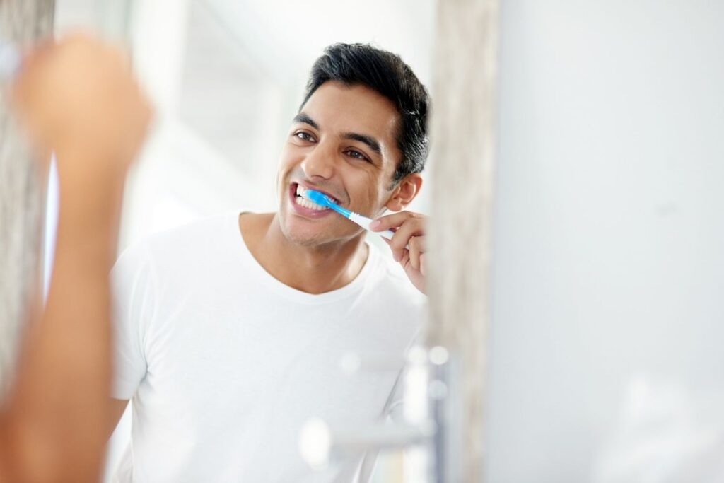 man brushing his teeth